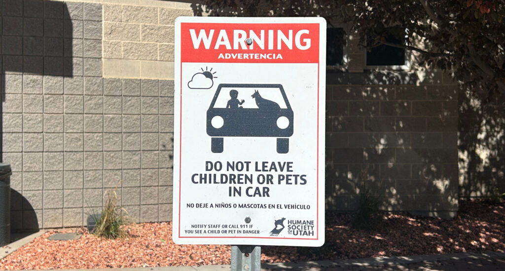 A sign in the parking lot of the Humane Society of Utah reads, "Warning! Do not leave children or pets in car"